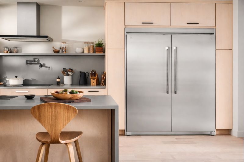 Electrolux EI33AF80WS upright freezer integrated in contemporary kitchen with wood cabinets