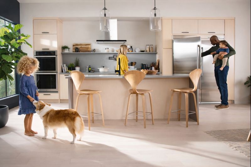 Family with children and dog in modern kitchen featuring Electrolux EI33AF80WS freezer