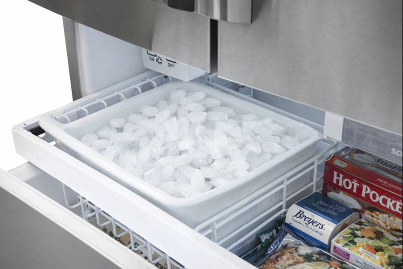 Open Electrolux EI32AF65JS upright freezer interior with organized frozen groceries and shelves