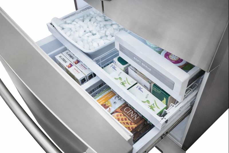 Open Electrolux freezer drawers showing full ice bin, soft serve ice cream, and stocked frozen foods