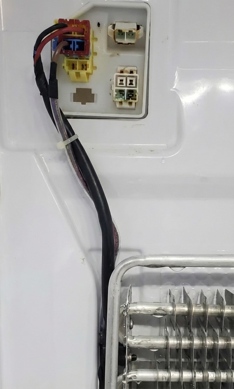 Sensor wiring connector in a freezer compartment being inspected